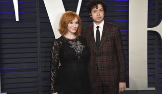 FILE - In this Feb. 24, 2019 file photo, Christina Hendricks, left, and Geoffrey Arend arrive at the Vanity Fair Oscar Party in Beverly Hills, Calif. Hendricks filed for divorce Friday, Dec. 13,  from her husband of 10 years, actor Geoffrey Arend.  Hendricks filed the marriage dissolution documents in Los Angeles Superior Court, citing irreconcilable differences.   (Photo by Evan Agostini/Invision/AP, File)