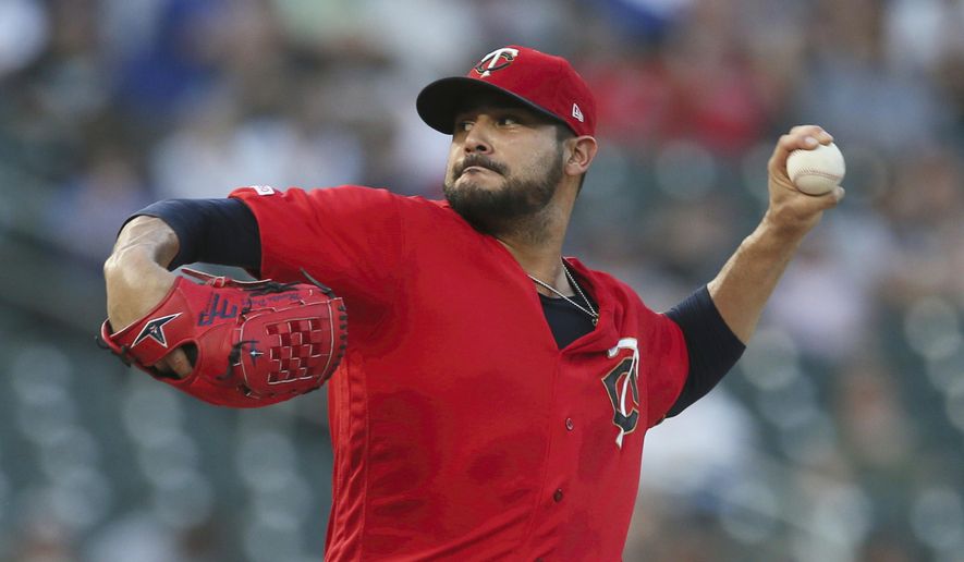 FIEL - In this Sept. 17, 2019, file photo, Minnesota Twins pitcher Martin Pérez throws against the Chicago White Sox in the first inning of a baseball game in Minneapolis. People familiar with the negotiations tell The Associated Press on Friday, Dec. 13, 2019, that the Boston Red Sox have agreed to one-year contracts with free agent left-hander Martin Pérez and shortstop José Peraza. The people spoke on the condition of anonymity because the deals had not yet been announced. (AP Photo/Jim Mone, File)