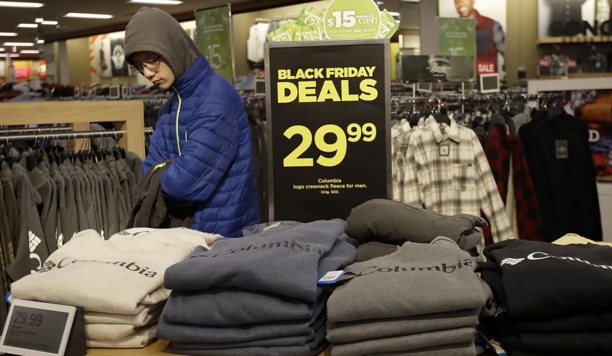 FILE- In this Nov. 29, 2019, file photo customers shop at a Kohl's store in Colma, Calif. On Friday, Dec. 13, the Commerce Department releases U.S. retail sales data for November. (AP Photo/Jeff Chiu, File)