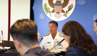 In this photo released by U.S. Embassy in Bangkok, U.S. Navy&#39;s Pacific Fleet Commander Adm. John Aquilino talks to reporters during an interview at U.S Embassy in Bangkok, Thailand, Friday, Dec. 13, 2019. China&#39;s activities in territory it claims in the South China Sea are meant to intimidate other nations in the region, the commander said. Adm. Aquilino said China&#39;s actions, including constructing islands in the disputed waters, are intended to project its military capacity. (U.S. Embassy in Bangkok via AP)