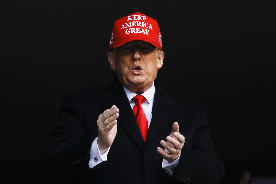 President Donald Trump watches the first half of an NCAA college football game between Army and Navy, Saturday, Dec. 14, 2019, in Philadelphia. (AP Photo/Matt Slocum)