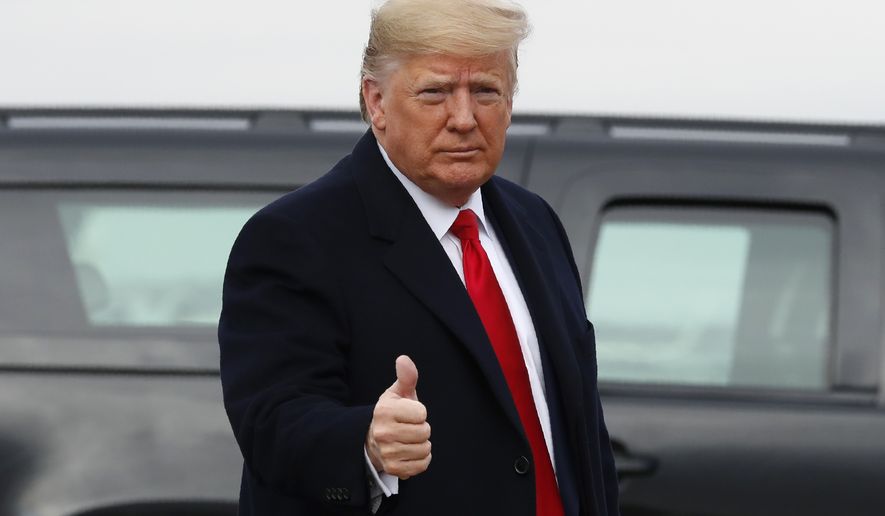 President Donald Trump makes the thumbs up sign as he exits a motorcade to board Air Force One at Andrews Air Force Base, Md., Saturday, Dec. 14, 2019, en route to Philadelphia to attend the Army-Navy football game. (AP Photo/Jacquelyn Martin)