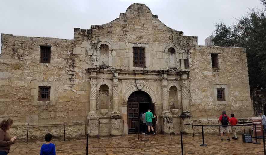 This Nov. 30, 2019 photo shows the church on the grounds of The Alamo in San Antonio, Texas. The remains of three people have been recovered from a burial room and the church. The Texas General Land Office said Friday, Dec. 13, 2019 that the remains believed to be an infant, a teenager or young adult and an adult were found in a burial room and Nave of the church during an archaeological exploration. The Alamo is the site of one of the most famous battles in American history in which nearly 200 Alamo defenders were killed in March 1836 in a battle with Mexican forces during the fight for Texas independence from Mexico (AP Photo/Ken Miller)