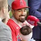 Los Angeles Angels&#39; Anthony Rendon looks over at his 17-month-old daughter, Emma during a news conference to welcome him to the baseball team in Anaheim, Calif., Saturday, Dec. 14, 2019. (AP Photo/Alex Gallardo) **FILE**