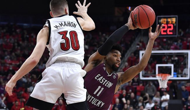 Eastern Kentucky guard Jomaru Brown (11) attempts to pass the ball as Louisville guard Ryan McMahon (30) defends during the first half of an NCAA college basketball game in Louisville, Ky., Saturday, Dec. 14, 2019. (AP Photo/Timothy D. Easley)