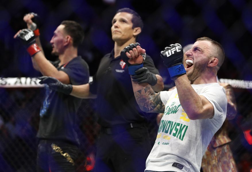 Alexander Volkanovski celebrates after defeating Max Holloway in a mixed martial arts featherweight championship bout at UFC 245, Saturday, Dec. 14, 2019, in Las Vegas. (AP Photo/John Locher)