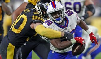 Pittsburgh Steelers outside linebacker T.J. Watt (90) strips the ball from Buffalo Bills running back Devin Singletary (26) and the Steelers recovered during the second half of an NFL football game in Pittsburgh, Sunday, Dec. 15, 2019. (AP Photo/Keith Srakocic)