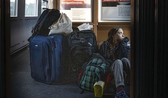In this image taken from Twitter feed of Climate activist Greta Thunberg, showing Thunberg sitting on the floor of a train surrounded by bags Saturday Dec. 14, 2019, with the comment “traveling on overcrowded trains through Germany. And I’m finally on my way home!”  The Tweet created a tweetstorm online Sunday about the performance of German railways, but the 16-year-old Swedish activist later sought to draw a line under the matter by tweeting that she eventually got a seat and that overcrowded trains are a good thing showing public transport is popular. (Twitter @GretaThunberg via AP)