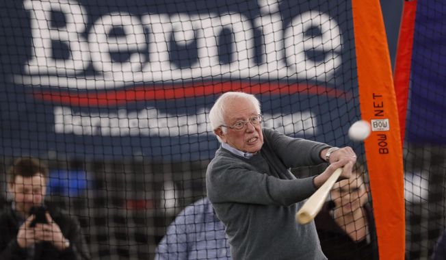 Democratic presidential candidate Sen. Bernie Sanders, I-Vt., hits a baseball after a meeting with minor league baseball players and officials at FunCity Turf, Sunday, Dec. 15, 2019, in Burlington, Iowa. (AP Photo/Charlie Neibergall)