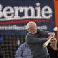 Democratic presidential candidate Sen. Bernie Sanders, I-Vt., hits a baseball after a meeting with minor league baseball players and officials at FunCity Turf, Sunday, Dec. 15, 2019, in Burlington, Iowa. (AP Photo/Charlie Neibergall)