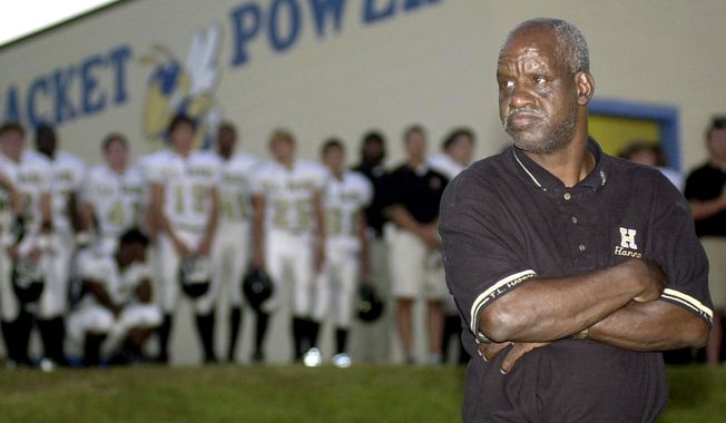 FILE - In this Sept. 19, 2003 file photo James &amp;quot;Radio&amp;quot; Kennedy stands with the T.L. Hanna High School varsity football team behind him just before Friday night&#x27;s game against Fort Mill in Fort Mill, S.C. Kennedy, the man who was a fixture on the sidelines of the South Carolina high school&#x27;s football games for decades and whose life inspired a Hollywood movie, died Sunday, Dec. 15, 2019. He was 73. (Amber M. McCloskey/The Herald via AP, File)