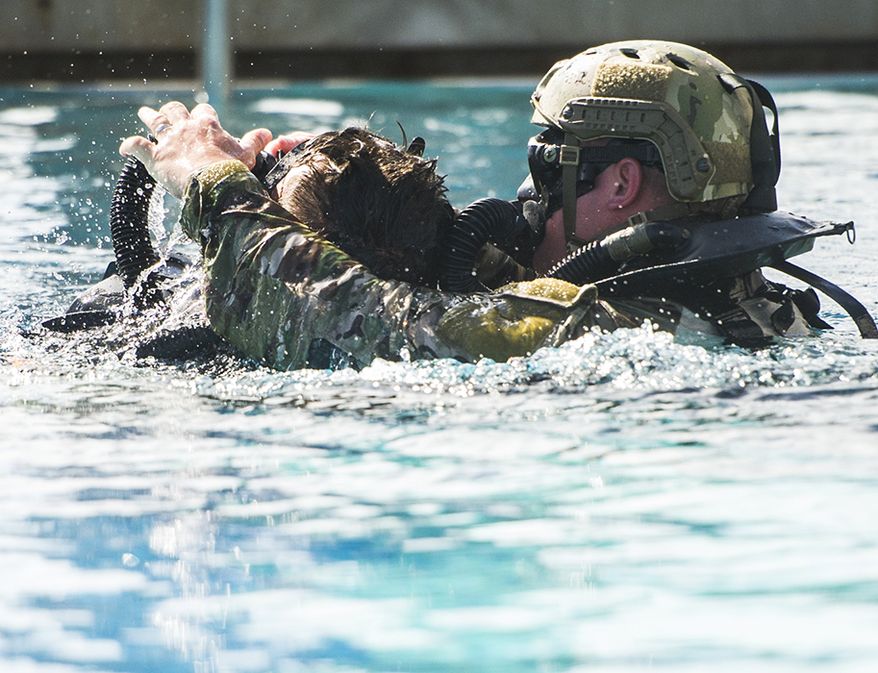 Special Forces Underwater Operations instructors demonstrate buddy rescue techniques by surfacing and initiating revive and resuscitate procedures on an "unconscious" diver at the SFUWO School located at Key West, Fl., Feb. 10, 2015. Instructors at SFUWO are expertly trained and safety is incorporated at all levels. Underwater operation is one of the many dynamic skills of the Green Berets. The SFUWO School is headquartered by the United States Army John F. Kennedy Special Warfare Center and School, the Army's Special Warfare Center of Excellence, Fort Bragg, N.C. (U.S. Army photo by Mr. John G. Martinez)
