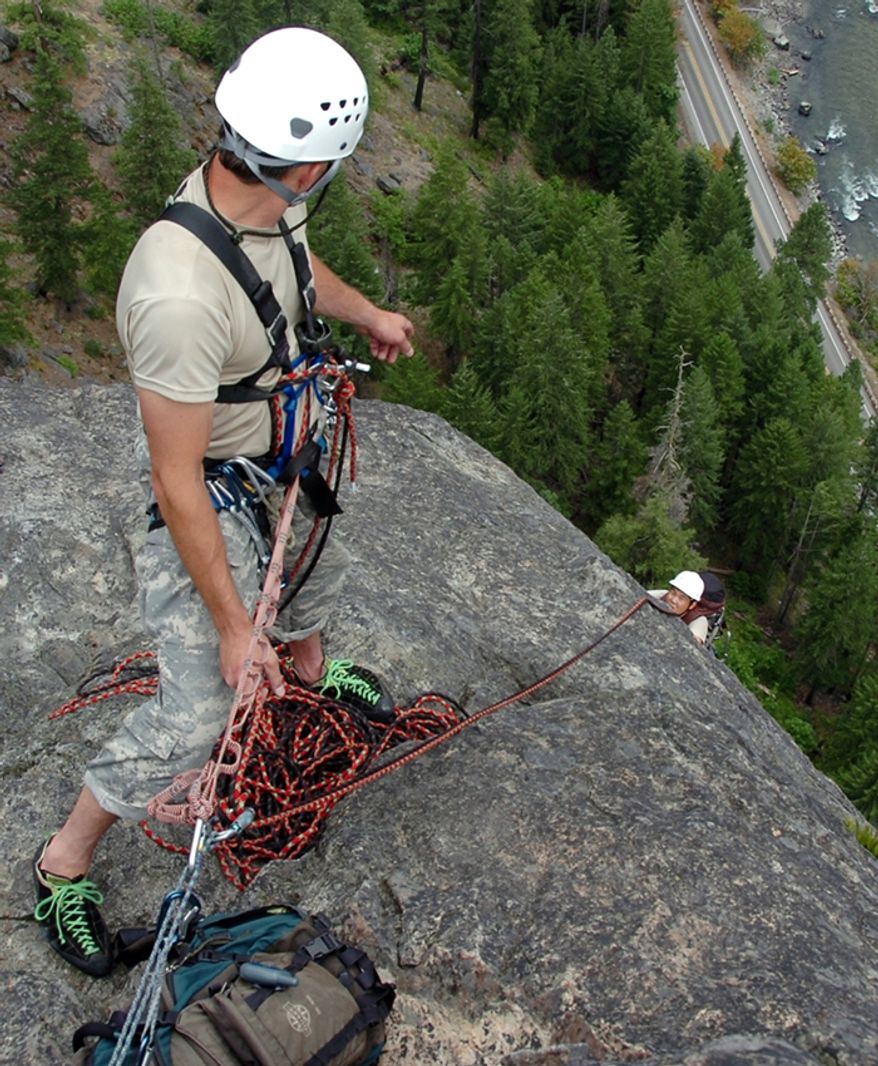 Green Berets of 1st Special Forces Group (Airborne) climb Castle Rock near Leavenworth, Wash. The Soldiers conducted military mountaineering training to maintain the skills that allow them to reach their objectives in mountainous terrain anywhere in the world. The Soldiers completed their mission to scale the 600-foot cliff face with packs despite 30 mile-per-hour wind gust and 95-degree Fahrenheit tempertures. (U.S. Army photo by Staff Sgt. Andrew Kosterman)