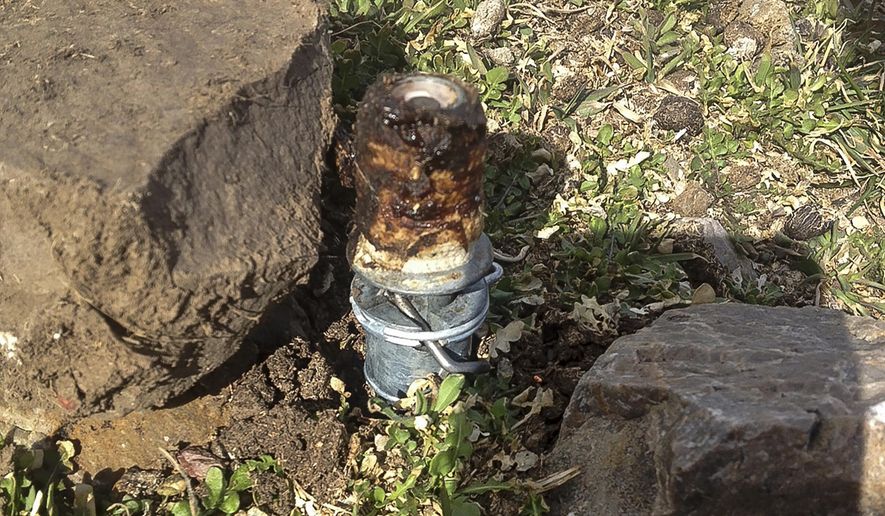 FILE - This March 16, 2017, file photo released by the Bannock County Sheriff's Office shows a cyanide trap in Pocatello, Idaho. The device is spring-activated and shoots poison that is meant to kill predators. A significant portion of a lawsuit brought by an eastern Idaho family against the U.S. government after a boy and his dog tripped the trap has been dismissed. The Agriculture Department has admitted placing the device in the wrong area, and the negligence portion of the lawsuit is moving forward. (Bannock County Sheriff's Office via AP, File)