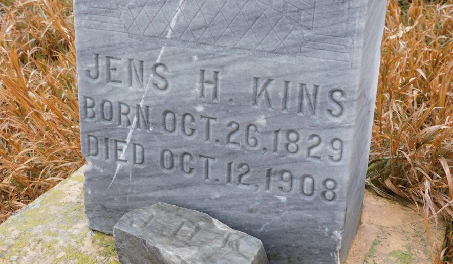 This tombstone and iron cross are located in what is known as the Three Graves Cemetery in McLean County, ND. While the tombstone bears an inscription of the deceased, there is no such identification on the cross. (Kim Fundingsland/Minot Daily News via AP)