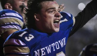 Newtown&#39;s Riley Ward (13) reacts and looks back at his teammates after scoring the winning touchdown as the Newtown Nighthawks beat the Darien Blue Wave in the final play of the Class LL state football championship at Trumbull High School Saturday, Dec. 14, 2019, in Trumbull, Conn. Newtown won 13-7. Newtown marked the seventh anniversary of the massacre at Sandy Hook Elementary School with vigils, church services and a moment of joy when the community&#39;s high school football team, with a shooting victim&#39;s brother as linebacker, won the state championship Saturday in a last-minute thrill. (Kassi Jackson/Hartford Courant via AP)