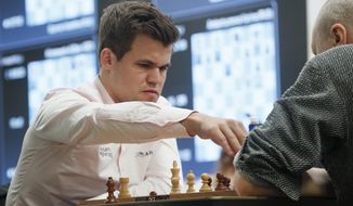 In this photo dated Wednesday, Dec. 26, 2018, Chess World Champion Magnus Carlsen (left) from Norway during a game against Russia&#x27;s Nikolai Vlassov during the World Rapid and Blitz Chess Championships in St. Petersburg, Russia. (AP Photo/Dmitri Lovetsky) **FILE**
