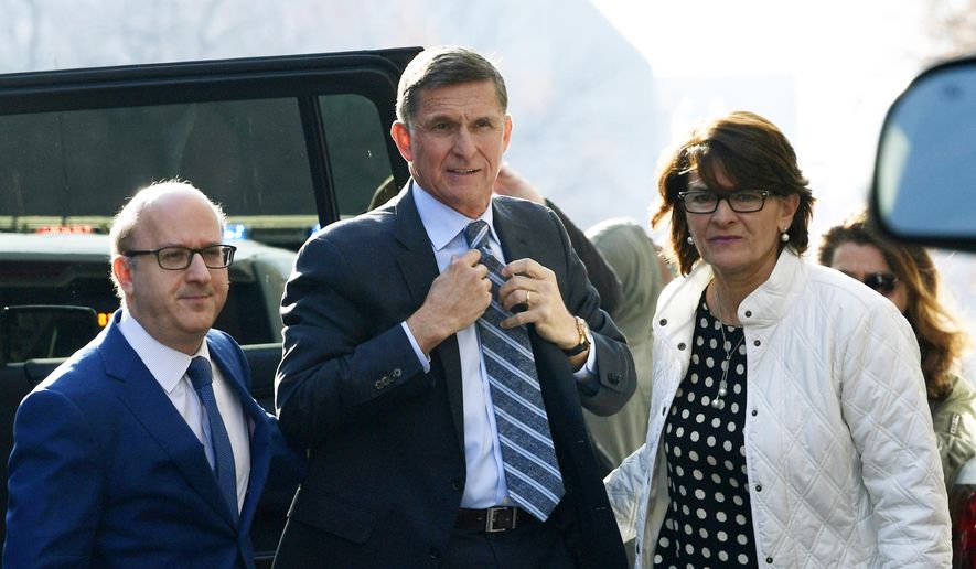 In this file photo, Michael Flynn, center, arrives at federal court in Washington. A judge set a sentencing hearing for Michael Flynn after rejecting arguments from the former Trump administration national security adviser that prosecutors had withheld evidence favorable to his case.  (AP Photo/Susan Walsh, File) **FILE**