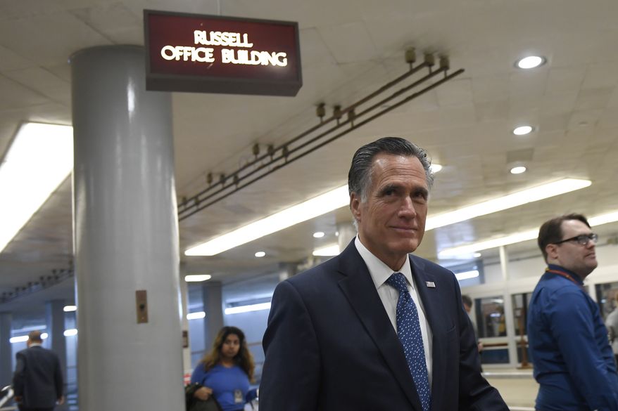 Sen. Mitt Romney, R-Utah, walks on Capitol Hill in Washington, Tuesday, Dec. 17, 2019. (AP Photo/Susan Walsh)