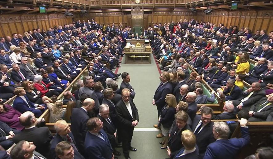 In this image taken from video, members of UK Parliament return to the House of Commons, London, Tuesday Dec. 17, 2019. Buoyed by a Conservative majority in Parliament, British Prime Minister Boris Johnson signaled Tuesday he won’t soften his Brexit stance, ruling out any extension of an end-of-2020 deadline to strike a trade deal with the European Union. (House of Commons via AP)