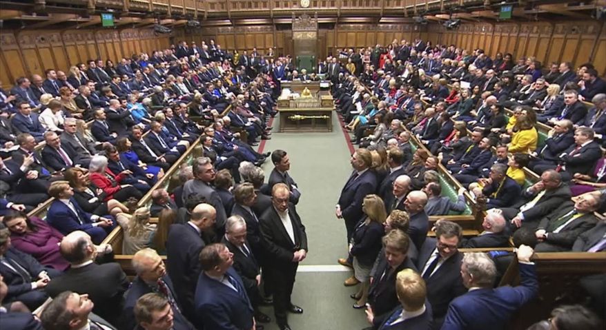 In this image taken from video, members of UK Parliament return to the House of Commons, London, Tuesday Dec. 17, 2019. Buoyed by a Conservative majority in Parliament, British Prime Minister Boris Johnson signaled Tuesday he won’t soften his Brexit stance, ruling out any extension of an end-of-2020 deadline to strike a trade deal with the European Union. (House of Commons via AP)