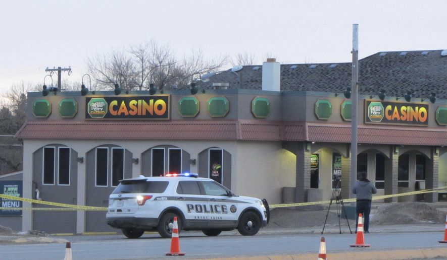 Police closed two westbound lanes of 10th Avenue South Tuesday, Dec. 17, 2019, after a triple homicide at the Emerald City Casino in Great Falls, Mont. (Traci Rosenbaum/The Great Falls Tribune via AP)