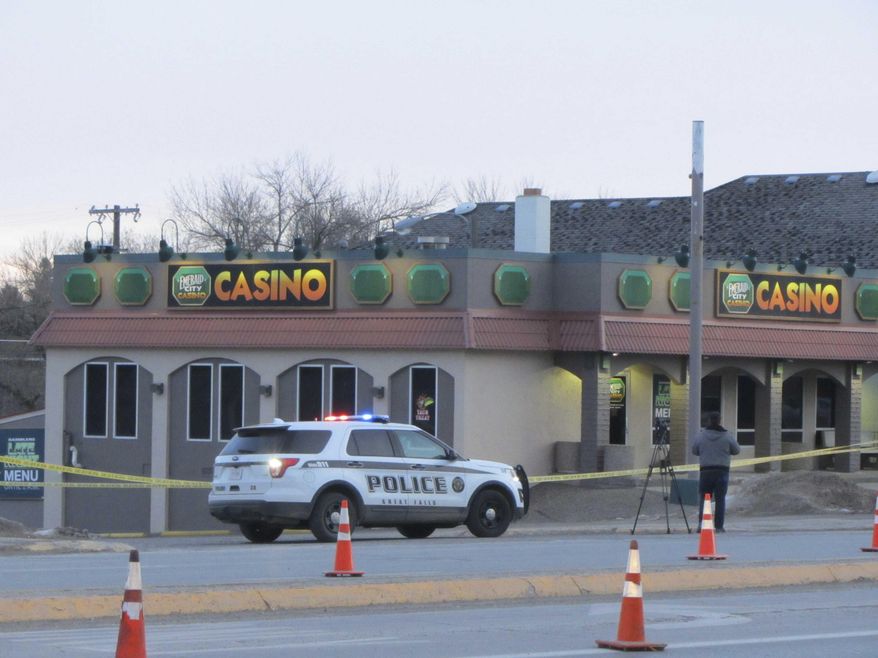 Police closed two westbound lanes of 10th Avenue South Tuesday, Dec. 17, 2019, after a triple homicide at the Emerald City Casino in Great Falls, Mont. (Traci Rosenbaum/The Great Falls Tribune via AP)