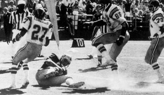 FILE - In this Sept. 11, 1978, file photo, Oakland Raiders&#39; Dave Casper falls in the endzone for a touchdown against the San Diego Chargers on the final play of a football game, in San Diego.  The stage was set in San Diego when the Raiders had the ball at the Chargers 14, trailing 20-14 with 10 seconds left. Ken Stabler dropped back to pass and was pressured by Chargers linebacker Woodrow Lowe. With nowhere to throw the ball, Stabler either fumbled or pushed the ball forward on purpose, depending on which side of the rivalry is telling the story. Teammate Pete Banaszak then knocked the ball further ahead from about the 13-yard line as it rolled toward the end zone. Tight end Dave Casper kicked the ball forward at the 5 and then fell on it in the end zone with no time remaining. (Thane McIntosh/The San Diego Union-Tribune via AP)