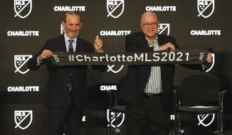 Major League Soccer Commissioner Don Garber, left, and Charlotte MLS team owner David Tepper announce that Major League Soccer will be coming to Charlotte in 2021 at an event in Charlotte, N.C., Tuesday, Dec. 17, 2019. (AP Photo/Nell Redmond