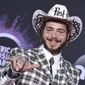 FILE - In this Nov. 24, 2019, file photo Post Malone arrives at the American Music Awards at the Microsoft Theater in Los Angeles. The rap-pop star will perform at “Dick Clark’s New Year’s Rockin’ Eve with Ryan Seacrest 2020” in New York City on Dec. 31, Dick Clark Productions announced Tuesday, Dec. 17. (Photo by Jordan Strauss/Invision/AP, File)