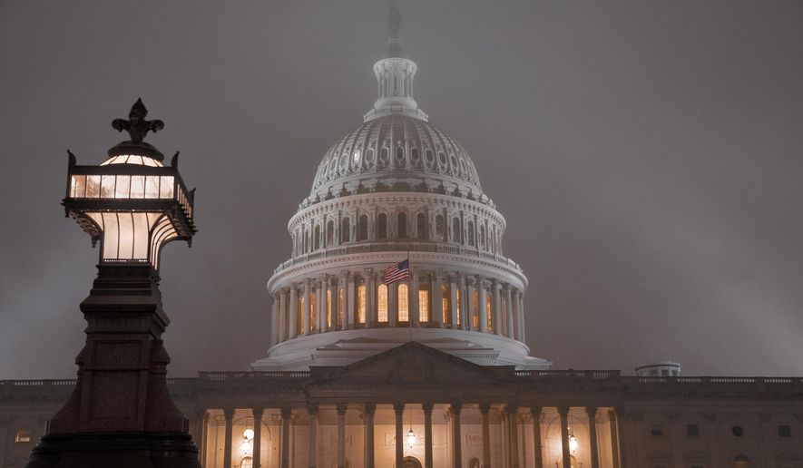 In this file photo, the U.S. Capitol in Washington is shrouded in mist, Friday night, Dec. 13, 2019. (AP Photo/J. Scott Applewhite)  **FILE**
