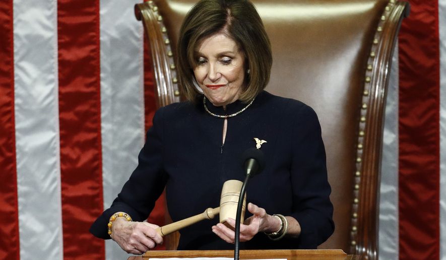 House Speaker Nancy Pelosi of Calif., holds the gavel after announcing the passage of the second article of impeachment, obstruction of Congress, against President Donald Trump by the House of Representatives at the Capitol in Washington, Wednesday, Dec. 18, 2019. (AP Photo/Patrick Semansky)