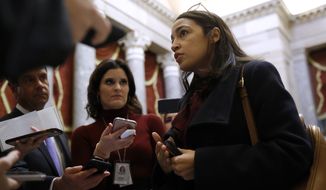 Rep. Alexandria Ocasio-Cortez, D-N.Y., speaks with reporters, Wednesday, Dec. 18, 2019, on Capitol Hill in Washington. President Donald Trump is on the cusp of being impeached by the House, with a historic debate set Wednesday on charges that he abused his power and obstructed Congress ahead of votes that will leave a defining mark on his tenure at the White House. (AP Photo/Patrick Semansky)