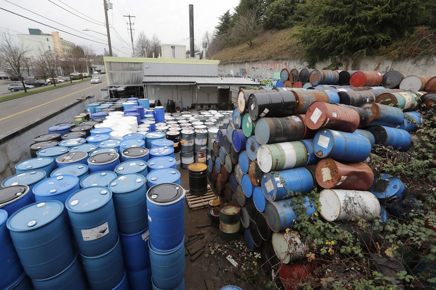 Dozens of barrels fill an outside storage area at Seattle Barrel and Cooperage Wednesday, Dec. 18, 2019, in Seattle. The century-old Seattle barrel company has been indicted along with its third-generation owner in what prosecutors describe as a long-running pollution conspiracy. The 36-count indictment, made public in U.S. District Court in Seattle on Wednesday, says the company used a hidden drain to pump caustic wastewater directly into the King County sewer system. That's despite telling officials that the company reused all its wastewater and didn't discharge any. (AP Photo/Elaine Thompson)
