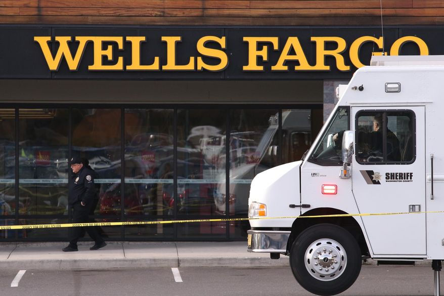 An attacker stabbed multiple people at a suburban Portland shopping center Wednesday, killing one person and wounding others before being apprehended, authorities said. Police in the city of Beaverton said that at least one person was stabbed inside a Wells Fargo bank and that multiple people were taken to hospitals. (Beth Nakamura/The Oregonian via AP)