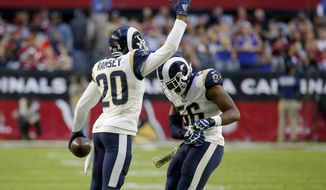 Los Angeles Rams cornerback Jalen Ramsey (20) celebrates his interception against the Arizona Cardinals with teammate defensive end Dante Fowler during the second half of an NFL football game, Sunday, Dec. 1, 2019, in Glendale, Ariz. (AP Photo/Rick Scuteri)