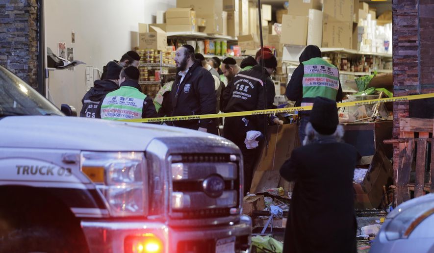 Emergency responders work at a kosher supermarket, the site of a shooting in Jersey City, N.J., Wednesday, Dec. 11, 2019. Jersey City Mayor Steven Fulop said authorities believe gunmen targeted the market during a shooting that killed multiple people Tuesday. (AP Photo/Seth Wenig) ** FILE **