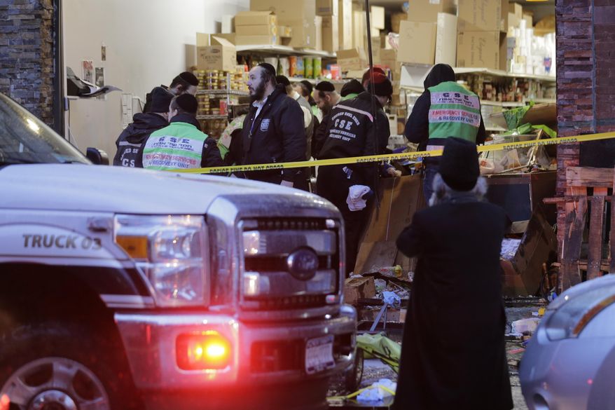 Emergency responders work at a kosher supermarket, the site of a shooting in Jersey City, N.J., Wednesday, Dec. 11, 2019. Jersey City Mayor Steven Fulop said authorities believe gunmen targeted the market during a shooting that killed multiple people Tuesday. (AP Photo/Seth Wenig) ** FILE **