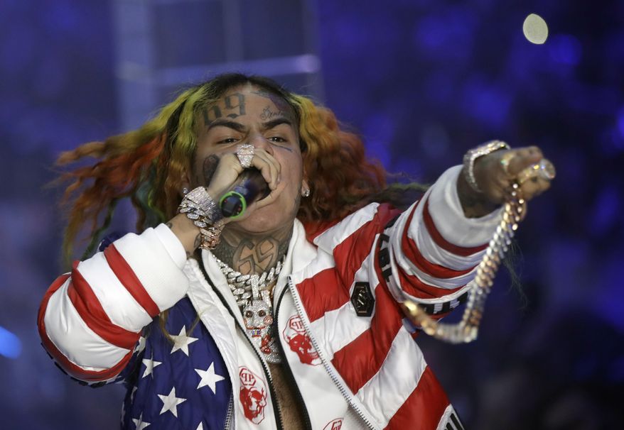In this Sept. 21, 2018, file photo rapper Daniel Hernandez, known as Tekashi 6ix9ine, performs during the Philipp Plein women's 2019 Spring-Summer collection, unveiled during the Fashion Week in Milan, Italy. Tekashi 6ix9ine was sentenced to two years in prison Wednesday, Dec. 18, 2019, for his entanglement with a violent street gang that fueled his rise to fame but was spared a much harsher possible sentence because of his extraordinary decision to become a star witness for prosecutors. (AP Photo/Luca Bruno, File)