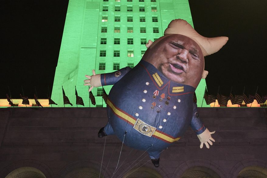 A Baby Trump Balloon floats outside City Hall in Los Angeles Tuesday, Dec. 17, 2019. President Donald Trump is on the cusp of being impeached by the House, with a historic debate set Wednesday on charges that he abused his power and obstructed Congress ahead of votes that will leave a defining mark on his tenure at the White House. (AP Photo/Damian Dovarganes)