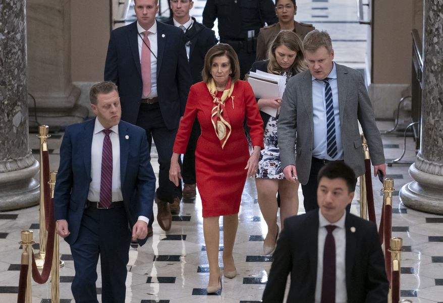 House Speaker Nancy Pelosi, D-Calif., walks from the chamber through Statuary Hall a day after the Democratic-controlled House of Representatives voted to impeach President Donald Trump on charges of abuse of power and obstruction of Congress, at the Capitol in Washington, Wednesday, Dec. 18, 2019. (AP Photo/J. Scott Applewhite)