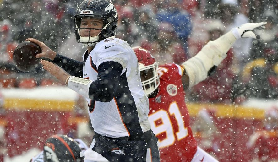 Denver Broncos quarterback Drew Lock (3) looks to throw a pass as Kansas City Chiefs defensive tackle Derrick Nnadi (91) pursues during the second half of an NFL football game in Kansas City, Mo., Sunday, Dec. 15, 2019. (AP Photo/Ed Zurga)