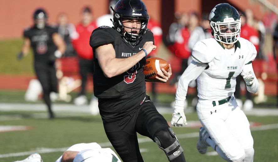 In this Nov. 9, 2019 photo, provided by North Central College Athletics, North Central quarterback Broc Rutter carries the ball against Illinois-Wesleyan during an NCAA college football game in Naperville, Ill. Rutter was selected to the Division III All-America first team on Thursday, Dec. 19, 2019. (Steve Woltmann/North Central College Athletics via AP)