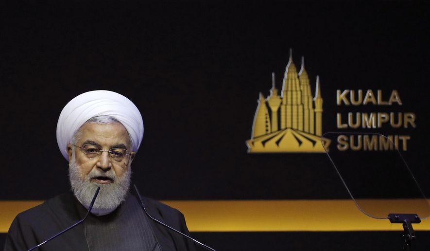 Iranian President Hassan Rouhani delivers a speech at the Kuala Lumpur Summit in Kuala Lumpur, Malaysia, Thursday, Dec. 19, 2019. Leaders from Turkey, Iran, Qatar, Indonesia and Malaysia address delegates during opening ceremony of the Kuala Lumpur Summit 2019, which aims to identify problems that affect the Muslim world.(AP Photo/Lai Seng Sin) ** FILE **