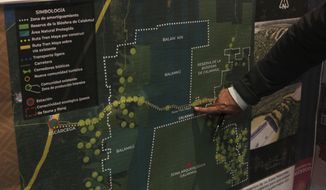 FILE - In this March 18, 2019 file photo, Rogelio Jiménez Pons, director of Fonatur, points to a map of a planned train line through the Yucatan Peninsula, during an interview in Mexico City. Mexico&#39;s President Andrés Manuel López Obrador claimed overwhelming support Monday, Dec. 16, 2019, after a weekend referendum on the train project produced lopsided results in a limited vote. (AP Photo/Marco Ugarte, File)