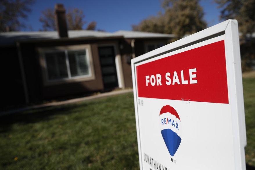 FILE - In this Oct. 22, 2019, file photo, a sign stands outside a home for sale in southeast Denver. On Thursday, Dec. 19, Freddie Mac reports on this week's average U.S. mortgage rates. (AP Photo/David Zalubowski, File)