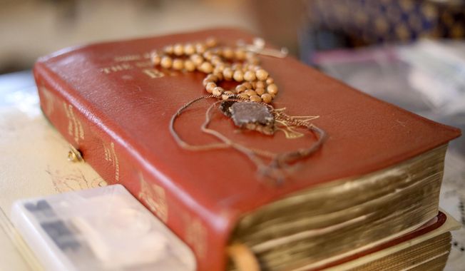 A rosary, scapular and Bible rest on a coffee table in Rancho Cucamonga, Calif., on Thursday, Sept. 26, 2019. (AP Photo/Wong Maye-E)  ** FILE ** 