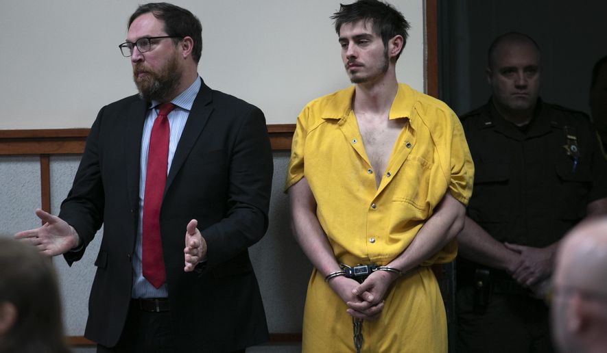 Quinton Hanna, 22, of Freeport, Maine, listens as his attorney, Andrew Wright, speaks at his arraignment in Cumberland County Superior Court Thursday, Dec. 19, 2019, in Portland, Maine. Hanna is charged with the fatal stabbing of James Pearson, an 82-year-old Christmas tree farm owner in Scarborough, Maine. (AP Photo/Robert F. Bukaty)