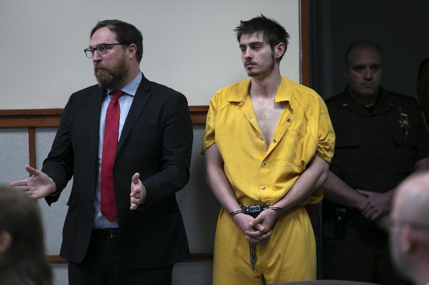 Quinton Hanna, 22, of Freeport, Maine, listens as his attorney, Andrew Wright, speaks at his arraignment in Cumberland County Superior Court Thursday, Dec. 19, 2019, in Portland, Maine. Hanna is charged with the fatal stabbing of James Pearson, an 82-year-old Christmas tree farm owner in Scarborough, Maine. (AP Photo/Robert F. Bukaty)