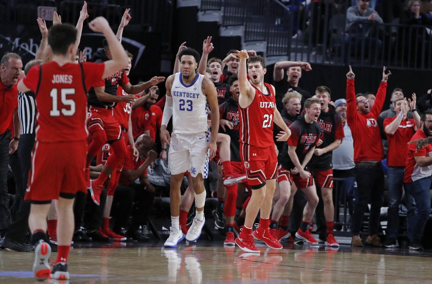 Utah's Riley Battin (21) celebrates after making a 3-point shot against Kentucky during the second half of an NCAA college basketball game Wednesday, Dec. 18, 2019, in Las Vegas. (AP Photo/John Locher)